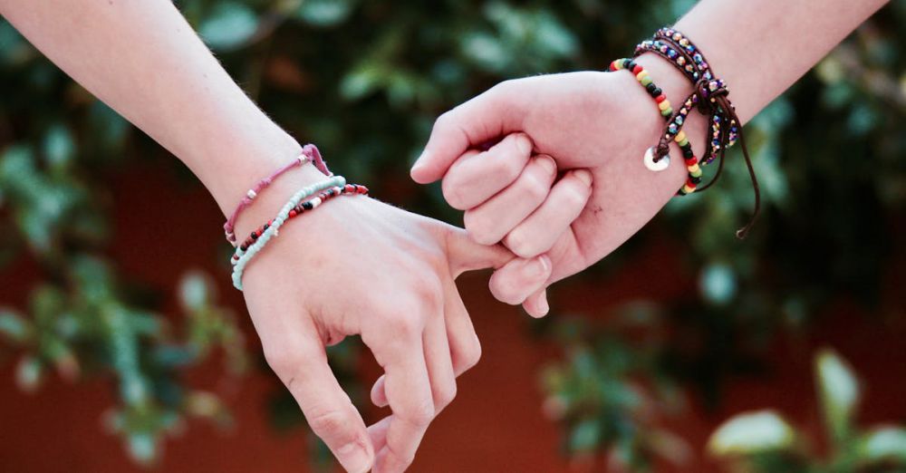 Bracelets - Two hands with colorful bracelets interlocked, symbolizing friendship and connection.