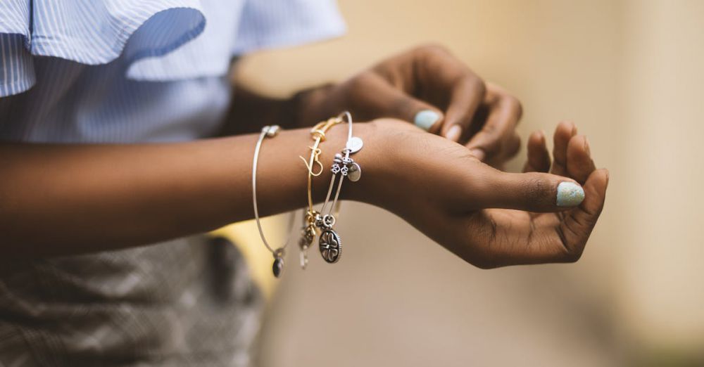 Jewelry - Close-up of a woman's hands adorned with stylish bracelets, showcasing modern fashion jewelry.