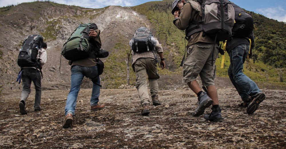 Backpacks - Five hikers with backpacks trekking up a mountain path in West Sumatra, Indonesia.