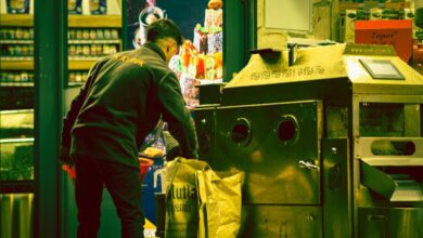 Work Bags - An adult male working next to a large industrial machine indoors. Captured with a unique color tone.
