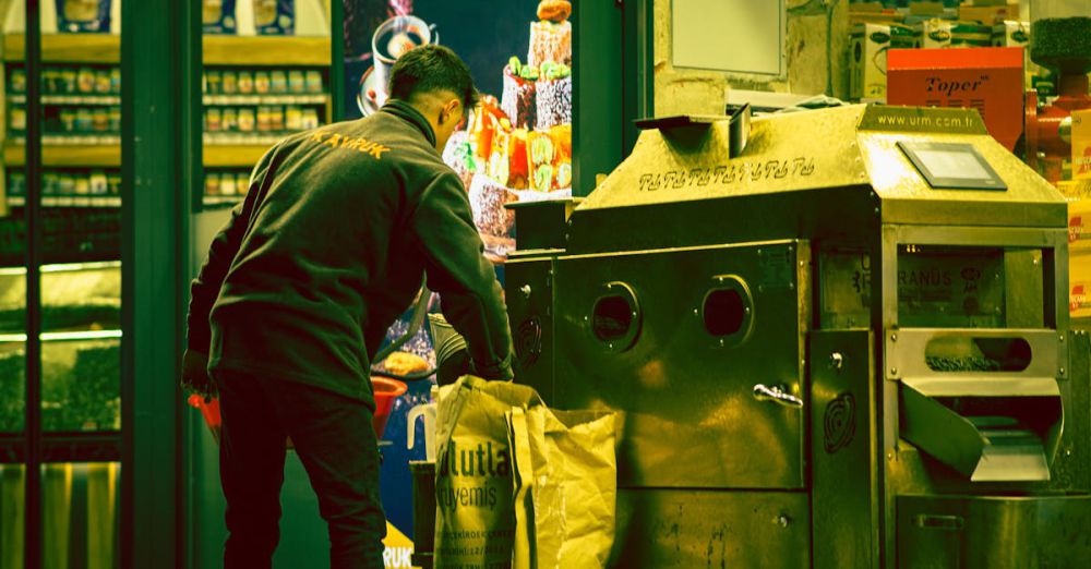 Work Bags - An adult male working next to a large industrial machine indoors. Captured with a unique color tone.