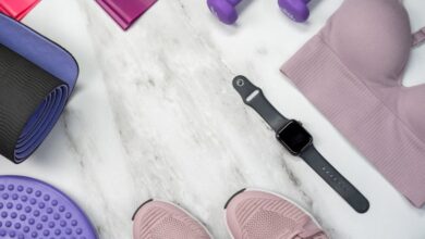 Resistance Bands - Flat lay of fitness gear including yoga mat, dumbbells, and smartwatch on a marble surface.