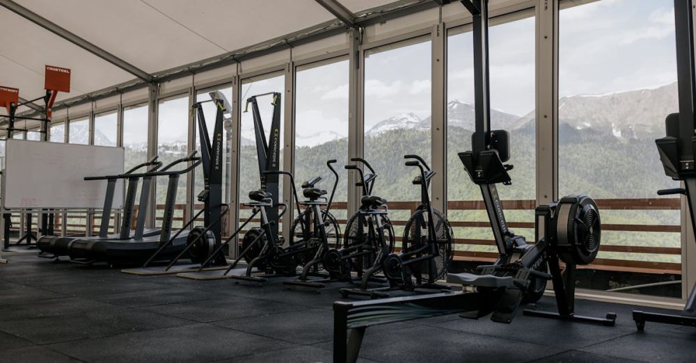 Treadmills - Spacious indoor gym featuring state-of-the-art equipment with scenic mountain views outside large windows.