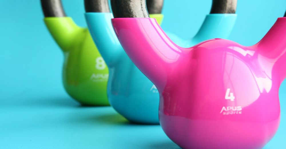 Kettlebells - Vibrant colored kettlebells on blue background highlighting fitness and exercise equipment.