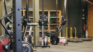 Rowing Machines - An indoor gym with various exercise equipment and weights ready for workout.