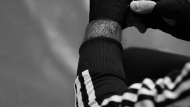 Boxing Equipment - Detailed black and white view of an athlete wrapping hands before training.