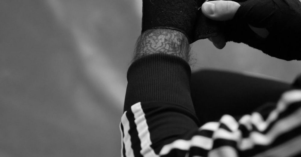 Boxing Equipment - Detailed black and white view of an athlete wrapping hands before training.