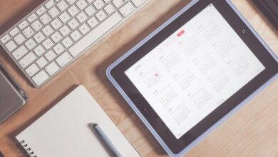 Calendar - A tidy desk setup featuring a tablet displaying a calendar, keyboard, and stationary items.