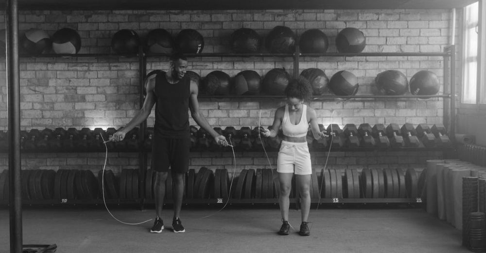 Jump Ropes - A fit couple working out in the gym with jump ropes, promoting a healthy lifestyle.