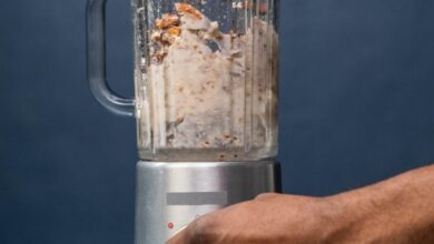 Food Processors - Close-up of hands preparing almond milk in a blender, showcasing a healthy lifestyle concept.