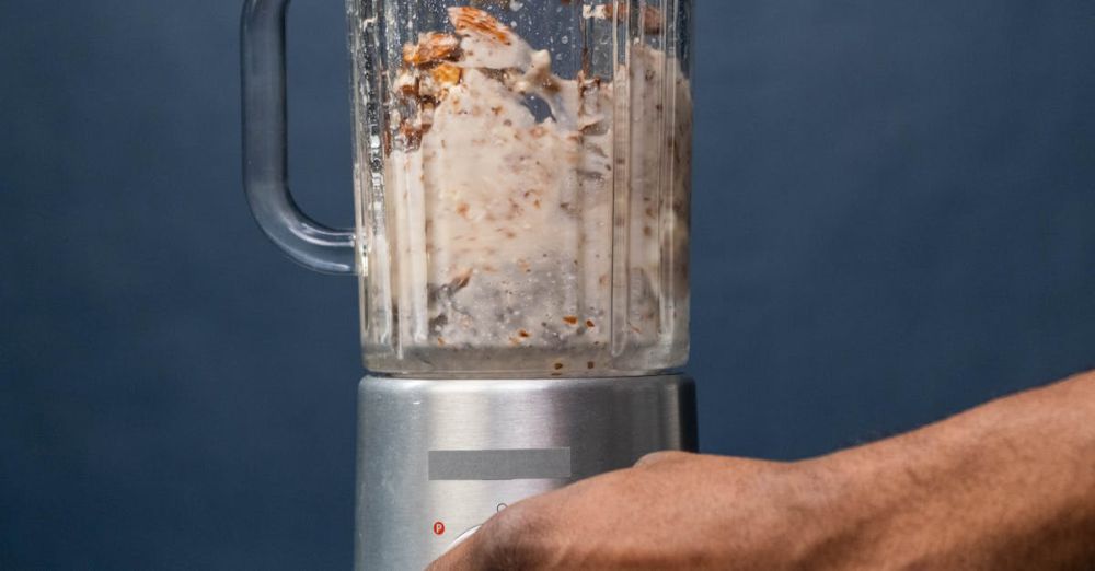 Food Processors - Close-up of hands preparing almond milk in a blender, showcasing a healthy lifestyle concept.