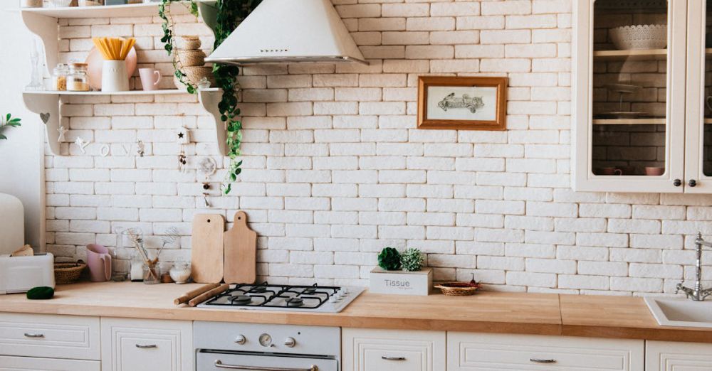 Cutting Boards - Stylish kitchen interior with modern appliances, wooden counters, and greenery accents.