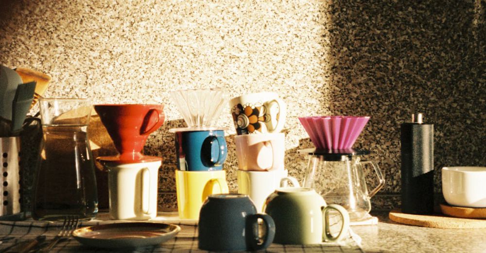 Coffee Makers - Sunlit kitchen counter with various coffee makers and mugs.