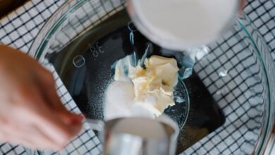 Kitchen Scales - Hands measuring sugar and butter in a bowl for a recipe. Perfect for baking enthusiasts.