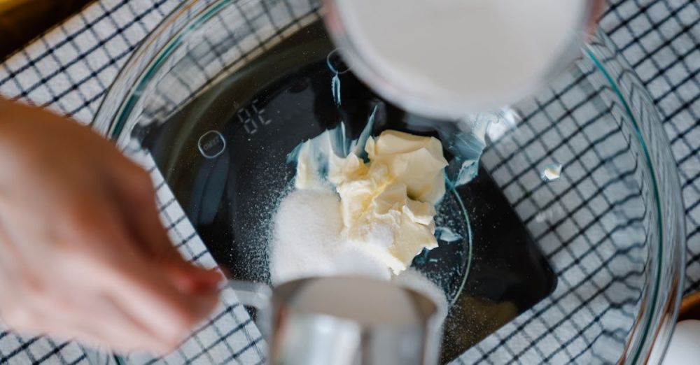 Kitchen Scales - Hands measuring sugar and butter in a bowl for a recipe. Perfect for baking enthusiasts.