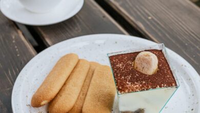 Ice Cream Makers - Tiramisu dessert with ladyfingers and coffee on a rustic wooden table outdoors.