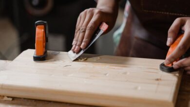 Tools - Hands crafting a wooden plank with clamps and tools. A focus on precision woodworking.