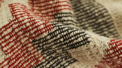 Rugs - Detailed view of a red and black checked handwoven textile showcasing texture and craftsmanship.