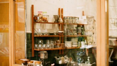 Storage Solutions - Warm coffee shop interior in Taiwan with wooden shelves and glassware.