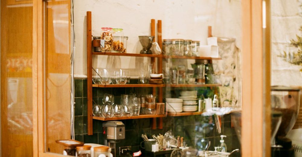 Storage Solutions - Warm coffee shop interior in Taiwan with wooden shelves and glassware.