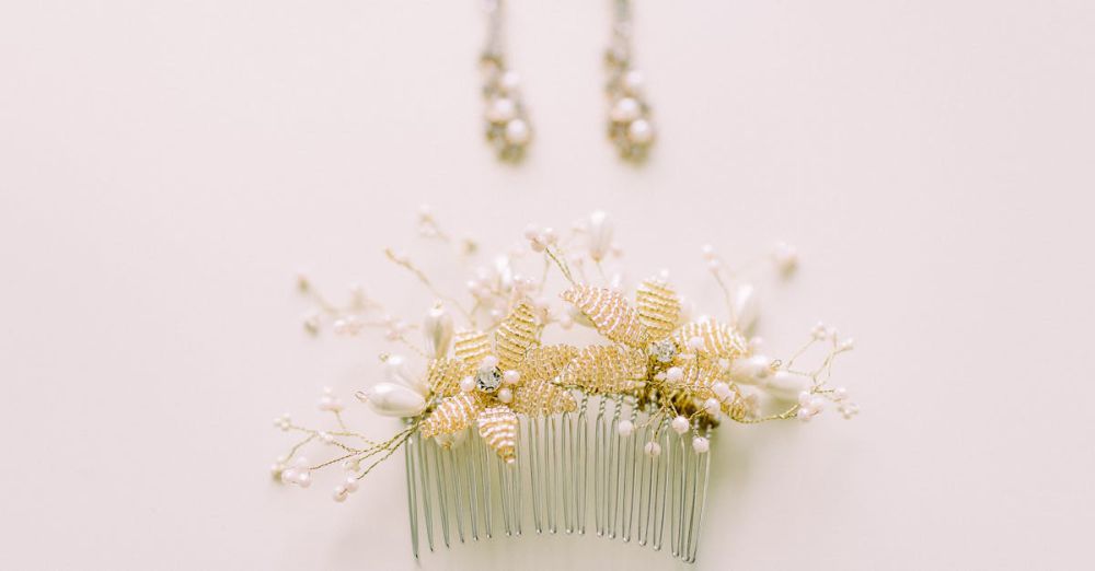 Accessories - Close-up of an ornate floral hair comb with matching earrings on a soft beige background.