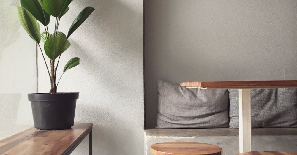 Stools - A minimalist, modern indoor seating area with wooden furniture and a potted plant, perfect for a cozy home interior.