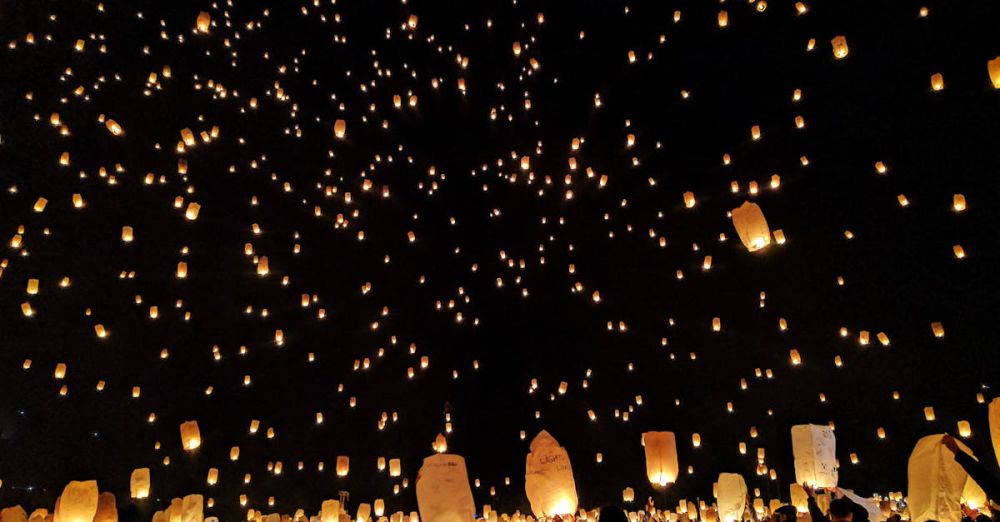 Lanterns - A mesmerizing scene of sky lanterns illuminating the night during a festive gathering, creating a magical atmosphere.