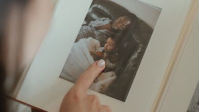 Book Boxes - A person reminiscing through a family photo album, highlighting precious moments.