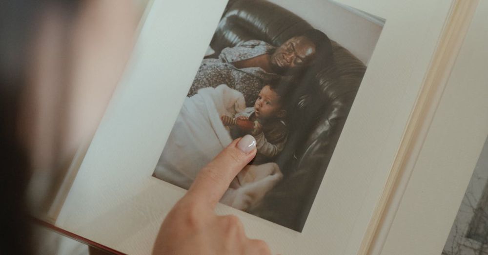 Book Boxes - A person reminiscing through a family photo album, highlighting precious moments.