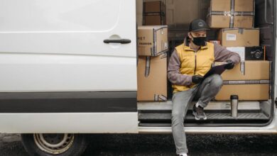 Fashion Boxes - Courier organizing packages and making notes while sitting in a delivery van.