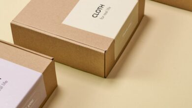 Eco Boxes - Three cardboard boxes arranged on a yellow surface, showcasing minimalist design for packaging.