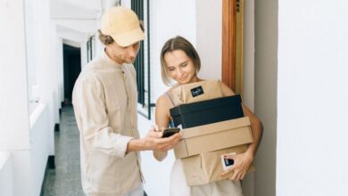 Gadget Boxes - A man and woman engaged in a home delivery package exchange, smiling.