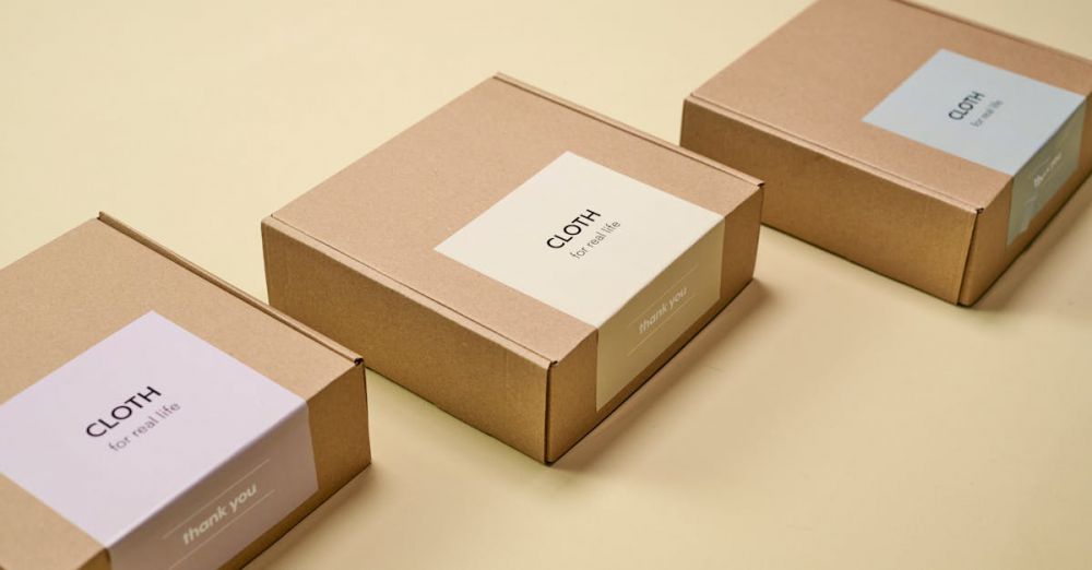 Stationery Boxes - Three minimalist cardboard packages labeled 'CLOTH' on a yellow background.