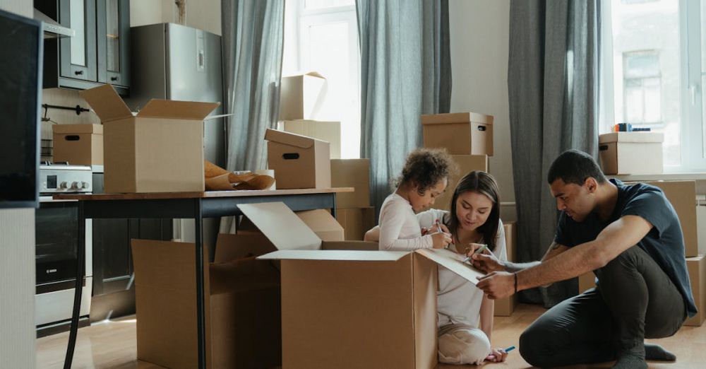 Couples’ Boxes - A family unpacks moving boxes in their new home kitchen, creating a cozy atmosphere.