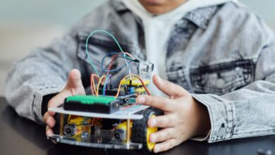 STEM Toys - A child working on a DIY robotics project with wires and wheels, showcasing innovation and creativity.