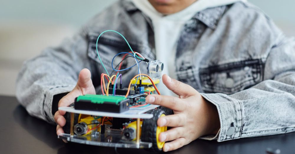 STEM Toys - A child working on a DIY robotics project with wires and wheels, showcasing innovation and creativity.