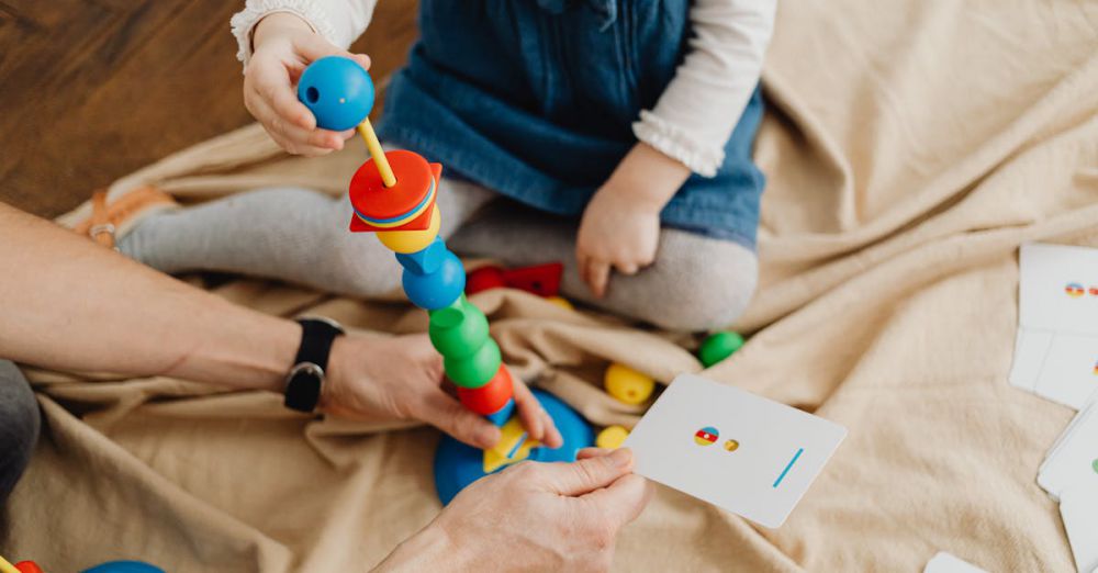 Flashcards - A child playing with colorful educational toys and flashcards indoors.