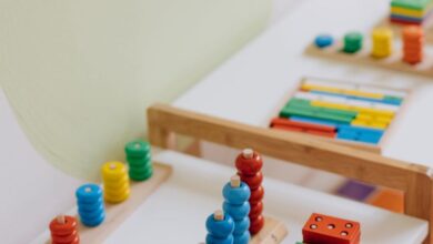 Math Toys - Bright and colorful educational wooden toys displayed on a table in a classroom.