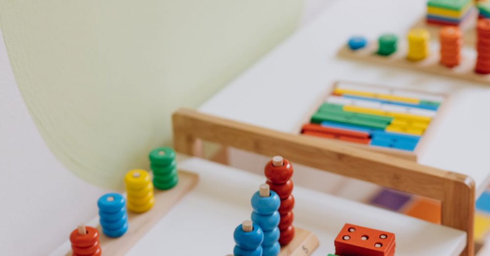 Math Toys - Bright and colorful educational wooden toys displayed on a table in a classroom.