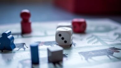 Board Games - Close-up view of board game pieces and dice on a game board. Perfect for recreation and strategy themes.