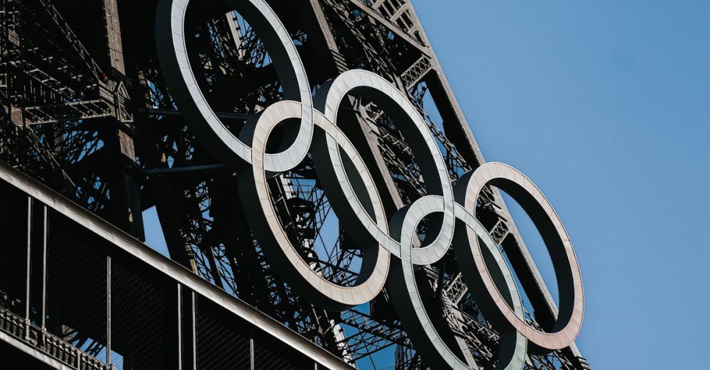 History Games - Close-up of the Eiffel Tower with Olympic rings in Paris, France.