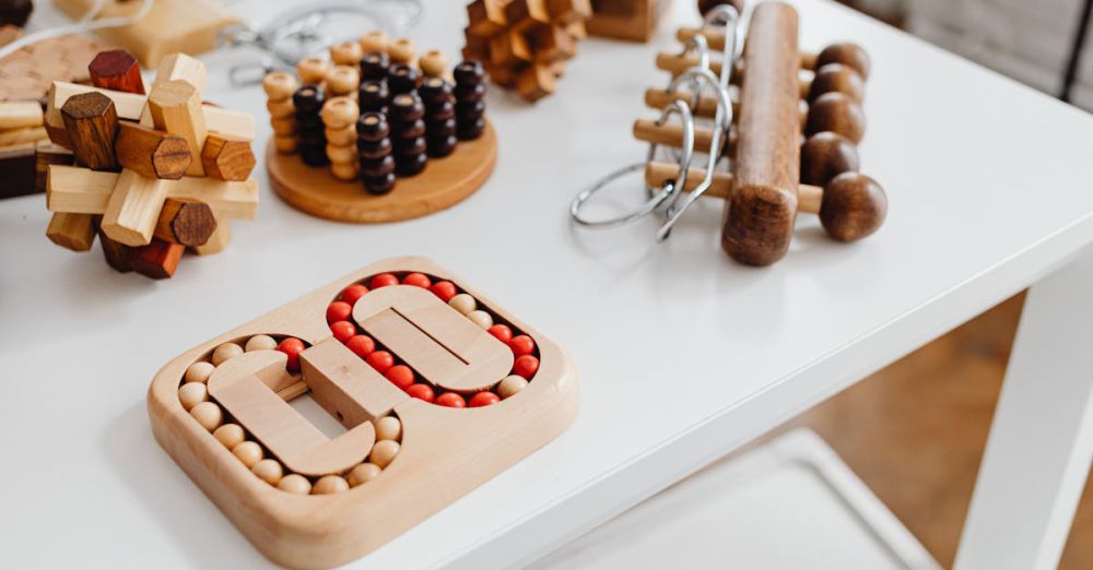 Logical Toys - A collection of wooden brain teasers and puzzles on a table, showcasing various designs and structures.