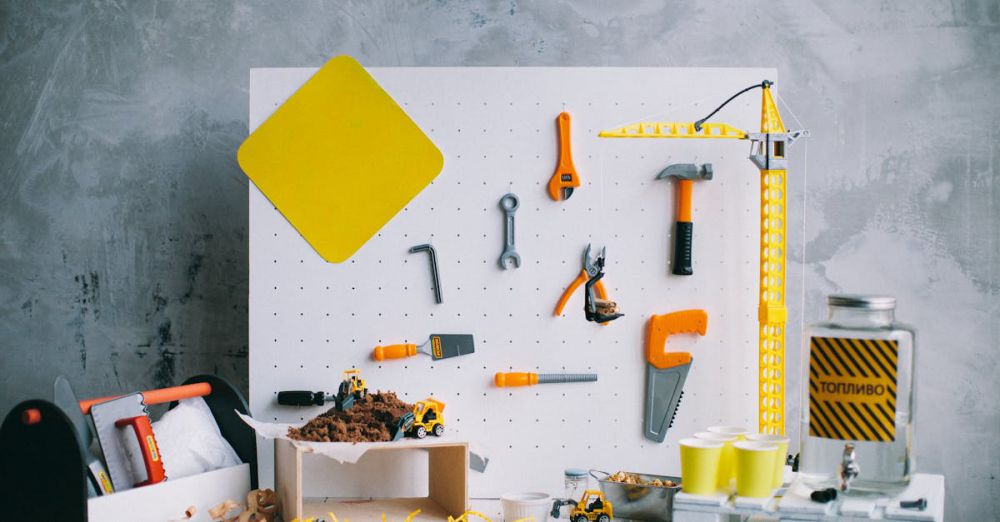 Play Tools - Artistic arrangement of toy tools and construction vehicles on a pegboard backdrop in a workshop setting.