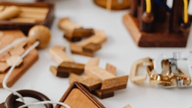 Problem-Solving Toys - A variety of wooden brain teasers and puzzles on a white tabletop.