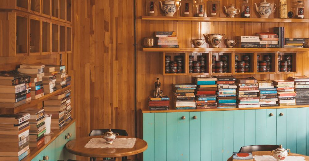 Coffee Tables - Warm and inviting coffee shop with books, wooden walls, and vintage decor.