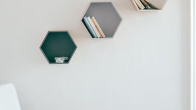 Shelving Units - A simple and elegant interior design featuring hexagonal wall shelves and a cozy armchair.