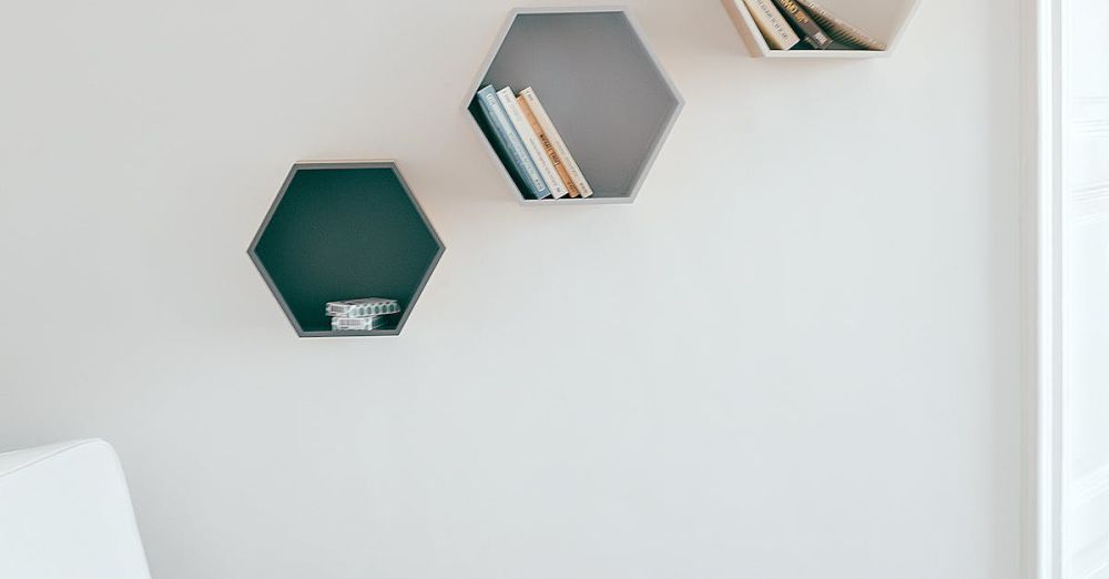 Shelving Units - A simple and elegant interior design featuring hexagonal wall shelves and a cozy armchair.