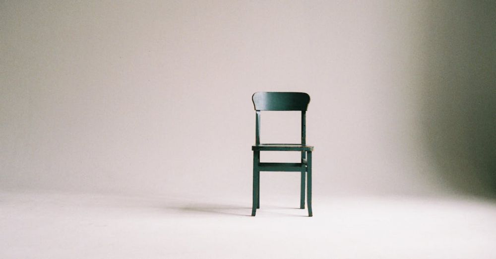 Chairs - A single black chair in a minimalistic studio setting with a neutral backdrop.