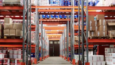 Storage Solutions - Wide angle view of a warehouse with stocked shelves and boxes.