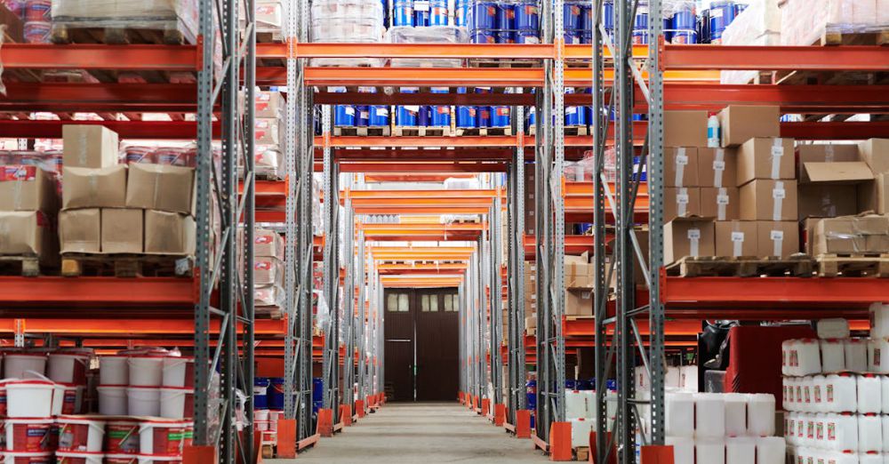 Storage Solutions - Wide angle view of a warehouse with stocked shelves and boxes.